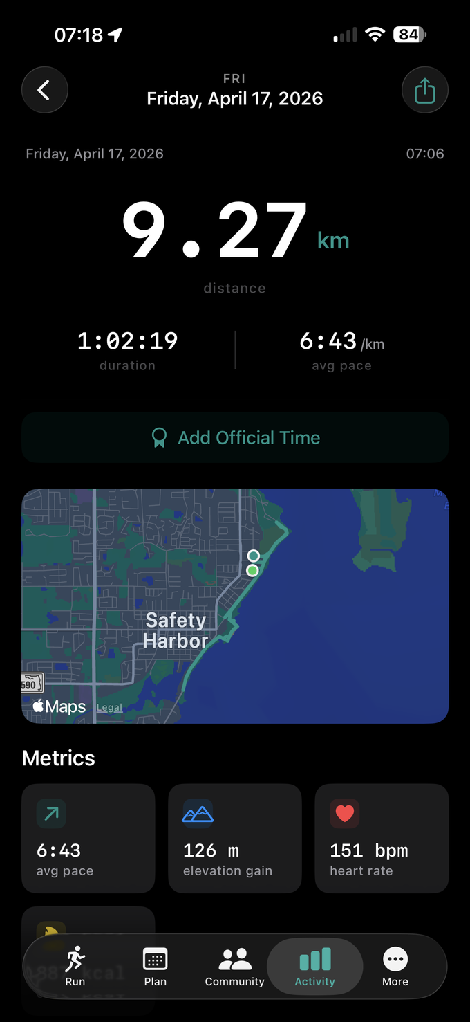 Post-run summary screen for a 9.27 km run on Friday April 17, 2026 — distance as the hero number, duration 1:02:19 and average pace 6:43/km below it, an Add Official Time button, the GPS route map over Safety Harbor, and a Metrics grid showing avg pace, elevation gain and heart rate.